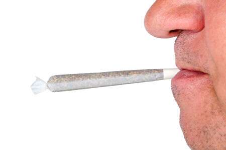 Man fave smoking a marijuana joint isolated on white background