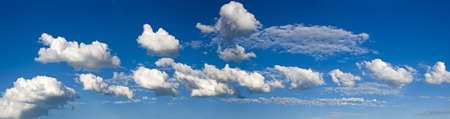 strip of white cumulus clouds in the pure blue sky  As clumps of cotton woolの写真素材