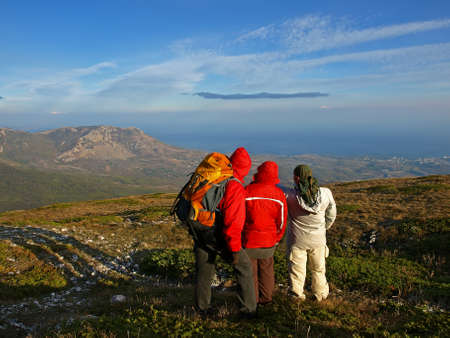 Mountain Crimea in the autumn. Tourists are turned away at the top of the mountain and inspect the neighborhood. The horizon line in the fog merges with the sea.の写真素材