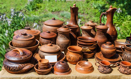 Ceramic dishes placed on the table in the garden  A table covered with burlap の写真素材