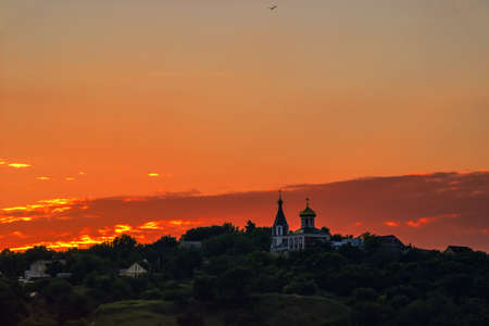 Red sunset over the hills  On the hill there is an old church  Vyshgorod, a suburb of Kiev, Ukraine の写真素材