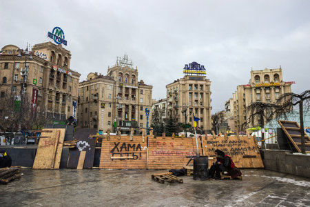 Ukraine, Kiev, December 2013  Protesters students bask in barrel with a bonfire on the background erected barricadesのeditorial素材