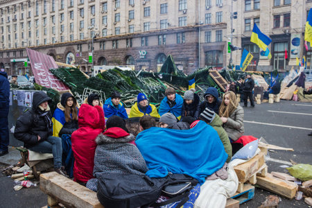 Kyiv, Ukraine, December 9, 2013  Students bask near the barrel with a bonfire during rallies on Maydan in Kiev のeditorial素材