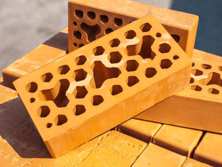 Few red bricks lying on the packaging of the same brickの写真素材