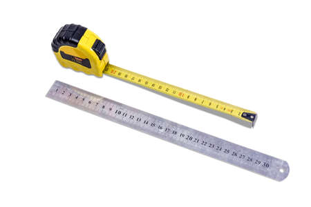 Yellow tape measure and metal ruler to measure the dimensions of the metric system on light background.  Isolation.の写真素材