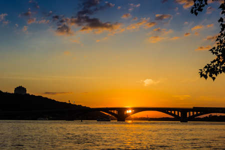 Sunset on the Dnieper. View of the bridges and right bank of Dnieper. Kyiv, Ukraine.の写真素材