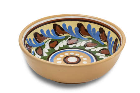 Ceramic bowl with floral ornaments on a light background. Isolation.の写真素材