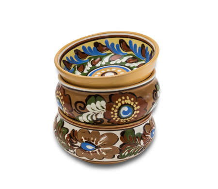 Several different  ceramic bowl with floral ornaments stacked one on one on a light background. Isolation.の写真素材