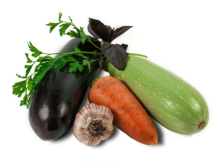 Eggplant carrot vegetable marrow garlic and branch of parsley and basil on a light background. Isolation.の写真素材