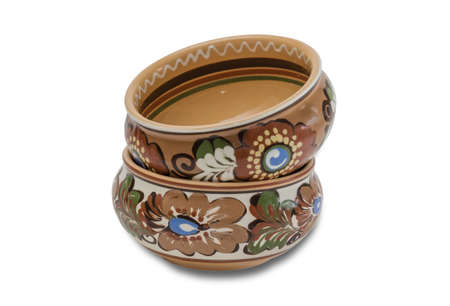 Two ceramic bowl with floral ornaments stacked one on one on a light background. Isolation.の写真素材