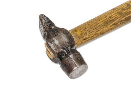 Old metalwork hammer with a wooden handle on a light . Isolation.の写真素材