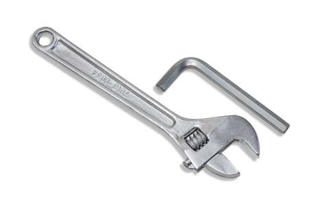 Silvery adjustable wrench and allen key on a light . Isolation.の写真素材