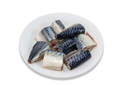 Pieces of raw mackerel on a white dish on a light background. Isolation.の写真素材