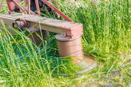 Tractor mounted rotary mower during operation closeupの写真素材
