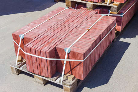 Wooden pallet with square red concrete pavers in depotの写真素材