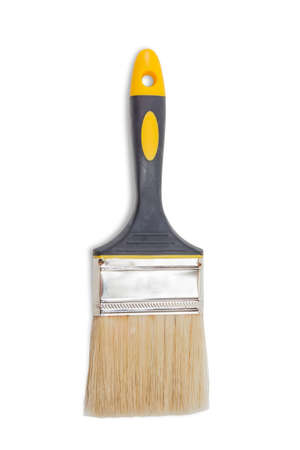 Wide flat paintbrush with rubberised black and yellow handle on a light background. Isolation.の写真素材