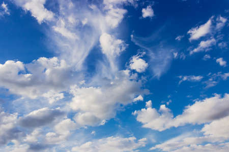 Fragment of sky with cumulus clouds and cirrus cloud summer in afternoonの写真素材
