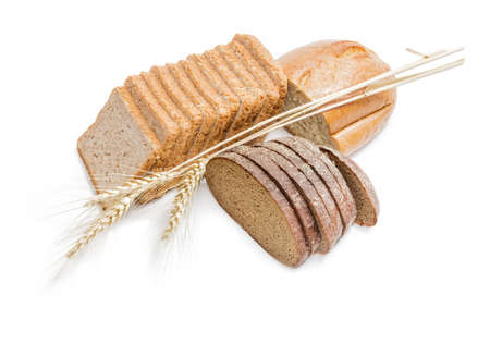 Sliced bread for toasting, wheat bread, sliced brown bread and spikelets of wheat on a light ....