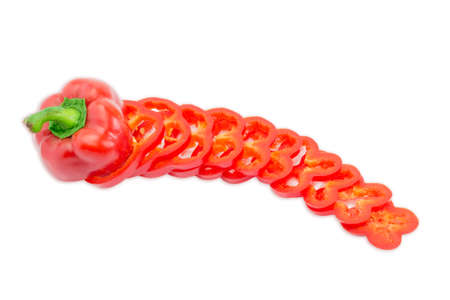 One fresh red bell pepper, part of which is sliced rings on a light background. Isolation.の写真素材
