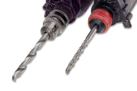 Twist drill bit for drilling metal and masonry drill bit in a chucks of a drill and a hammer drill closeup. Isolation.の写真素材