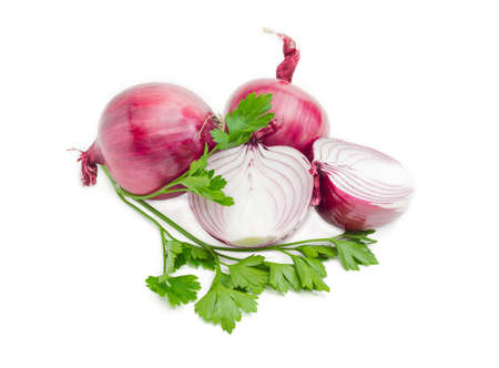 Three red onion one of them is cut in half and a branch of parsley on a light background. Isolation.の写真素材