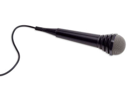 Dynamic microphone in black plastic housing with a cable and windscreen in wire mesh on a light backgroundの写真素材