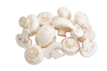 Pile of uncooked wholes and halfs of champignon mushroom closeup on a light background. Isolationの写真素材