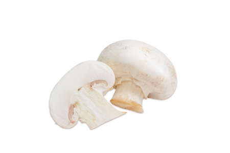 One whole and one half of uncooked champignon mushroom closeup on a light background. Isolationの写真素材