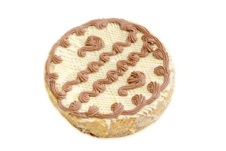 Round sponge cake, decorated floral pattern, made from cream with cocoa powder on a light background. Isolationの写真素材