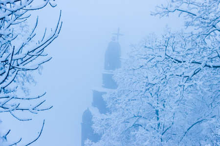 Built in the mid nineteenth century Saint Vladimir Monument in the fog during a heavy snowfall. Kiev, Ukraine.の写真素材