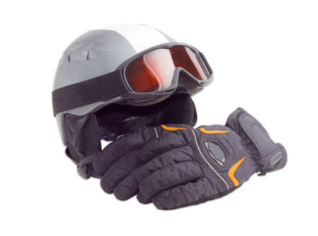 Gray protective ski helmet, ski goggles and black ski glove on a light backgroundの写真素材