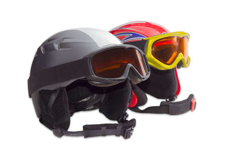 One gray and one red protective ski helmets with ski goggles on a light backgroundの写真素材