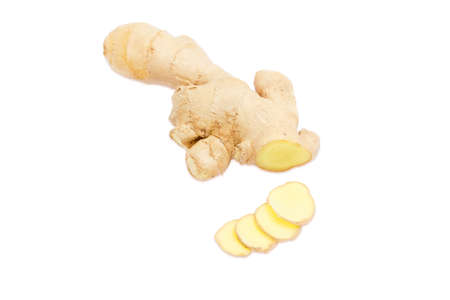 Piece of fresh ginger root and a few slices of a ginger on a light backgroundの写真素材