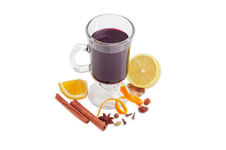 Mulled wine in glass mug and mulling spices for its cooking on a light backgroundの写真素材