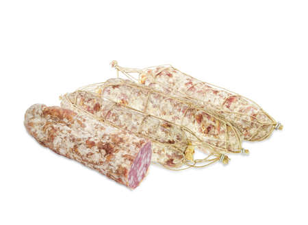 Several whole italian salami, tied with twine and one cut salami on a light backgroundの写真素材