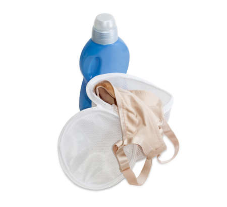 Special laundry bag for washing bras in washing machine against the background blue plastic bottle of a detergent on a light backgroundの写真素材