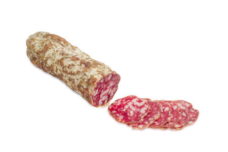 Italian salami, partly sliced thin slices on a light backgroundの写真素材