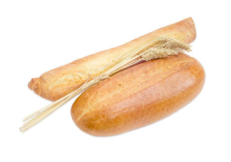 Fresh baguette, wheat bread and bundle of wheat ears on a light backgroundの写真素材