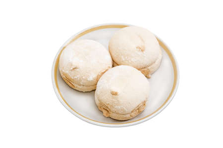 Light coffee-colored zefir - soft confectionery similar to marshmallow on a saucer on a light backgroundの写真素材