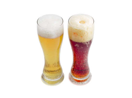 One beer glass lager beer and one beer glass dark beer with foam on a light backgroundの写真素材