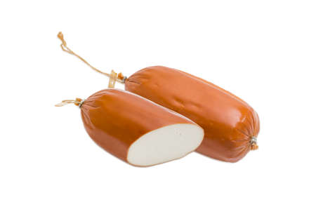 One whole smoked processed cheese in the form of sausage and one cut cheese on a light backgroundの写真素材