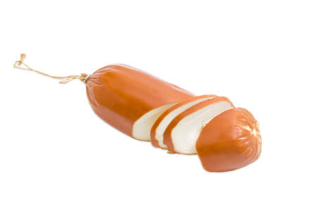 One smoked processed cheese in the form of sausage partly sliced on a light backgroundの写真素材