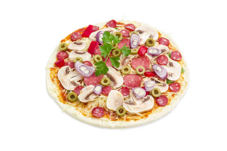 Uncooked round pizza with various sausages, button mushrooms, bell pepper and olives on a light backgroundの写真素材