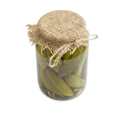 Homemade pickled cucumbers with spices in glass jar on a light backgroundの写真素材