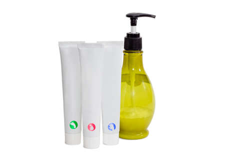 Three white tubes of moisturizer cream for skin care, cream for hand and cream for feet and bottle with cosmetics on a light backgroundの写真素材