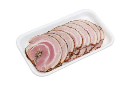 Sliced roll of a baked pork belly with layers of muscle and fats on a plastic tray on a light backgroundの写真素材