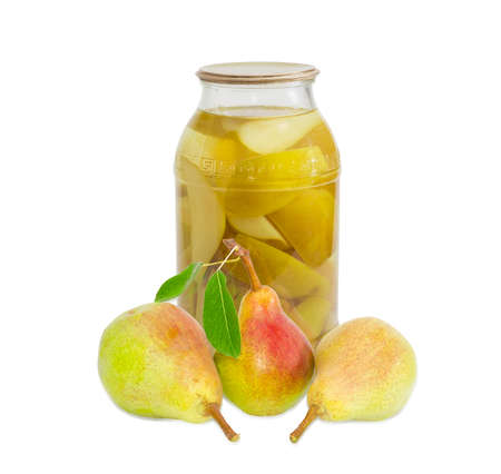 Three fresh pears Bartlett with leaves and canned pears in glass jar on a light backgroundの写真素材