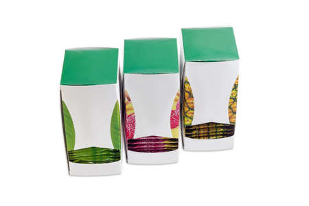 Three pasteboard boxes of  green tea with various fruit additives in tea bags on a light backgroundの写真素材