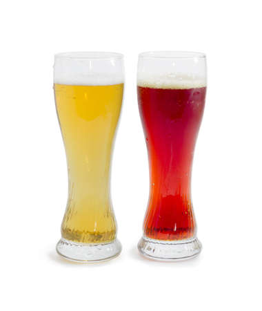 One beer glass lager beer and one beer glass dark beer with foam on a light backgroundの写真素材