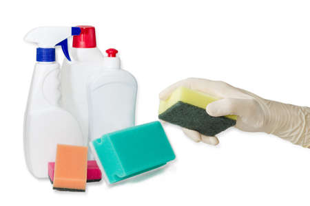 Hand in household rubber glove with synthetic cleaning sponge with layer for more intense scrubbing against the backdrop of other cleaning sponges and cleaning agents on a light backgroundの写真素材